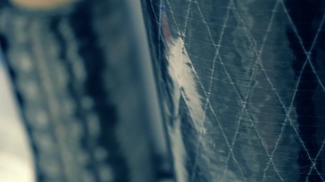 Coils of carbon fiber of which then weave a fabric for the manufacture of high-strength parts. Shot in motion
