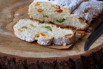 Christmas cake with candied fruits. Stollen is a traditional German cake on the stump.