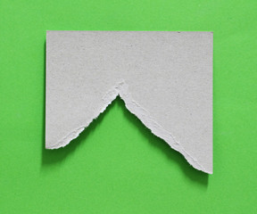 Torn white paper with green color as background