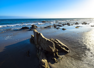 Rock formations in the late afternoon on El Matator State Beach in Malibu, California