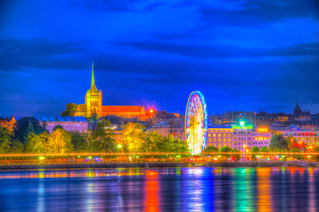 Night view of cityscape of Geneva dominated by Saint Pierre Cathedral, Switzerland