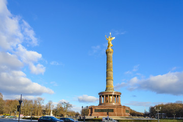 Fototapeta na wymiar Outdoor scenery of Victory Column, roundabout and vehicles on the road in Berlin, Germany.