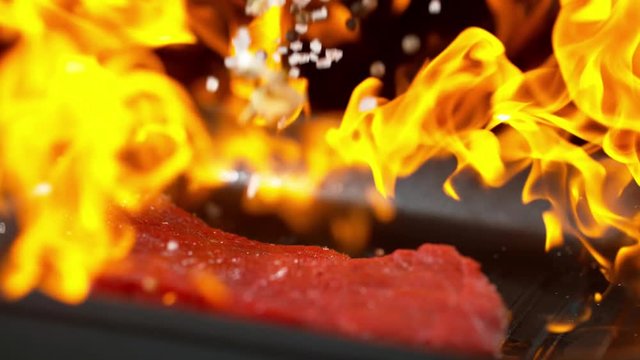 Super slow motion of falling beef steak into flames. Filmed on high speed cinema camera, 1000 fps.