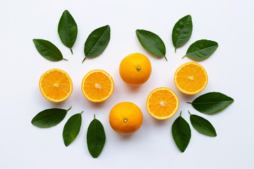Oranges and green leaves on white background.