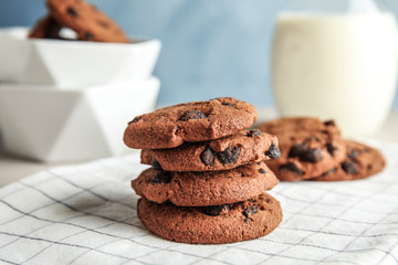 Stack of tasty chocolate chip cookies on table