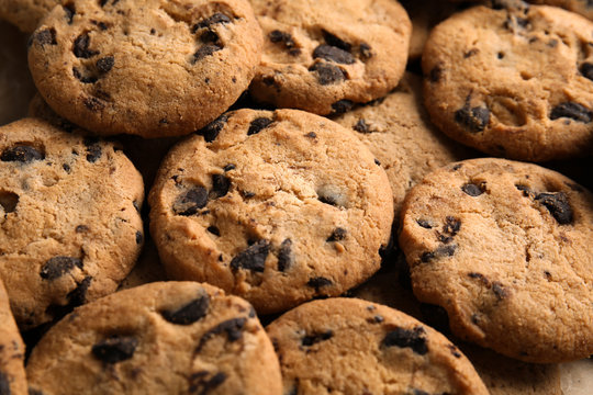 Tasty chocolate chip cookies as background, closeup