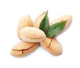 Heap of pecan nuts in shell and leaves on white background, top view