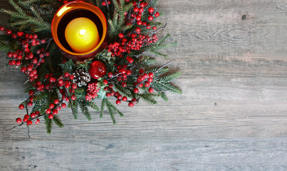 Christmas Candle with Evergreen Tree Branches and Berries Over Rustic Wood Background Shot From Directly Above, Copy Space