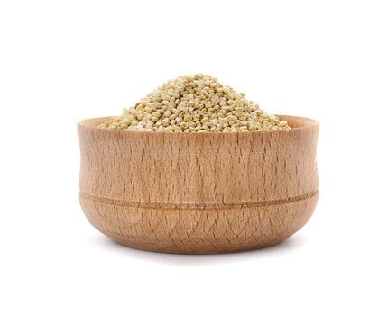 Bowl with raw quinoa on white background