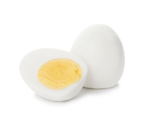 Sliced and whole hard boiled eggs on white background
