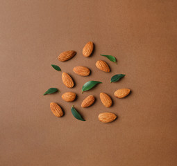 Fototapeta na wymiar Composition with organic almond nuts on color background, top view