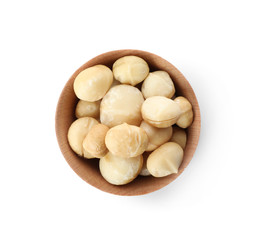 Bowl with shelled organic Macadamia nuts on white background, top view