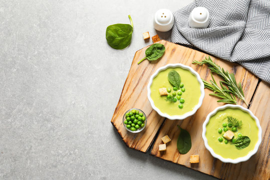 Fresh vegetable detox soup made of green peas and spinach served on table, top view with space for text