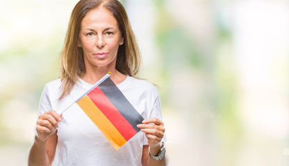 Fototapeta premium Middle age hispanic woman holding flag of Germany over isolated background with a confident expression on smart face thinking serious