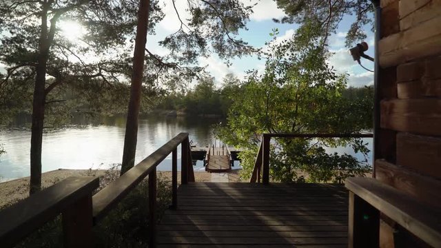 A wooden cottage near lake or sea. Luxury house for vacations. Summer day