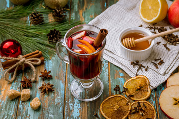 Mulled wine on old wooden background