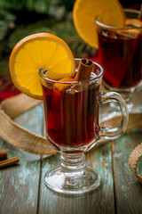 Mulled wine on old wooden background