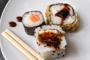 Uramaki and Hot Roll on a plate with chopsticks