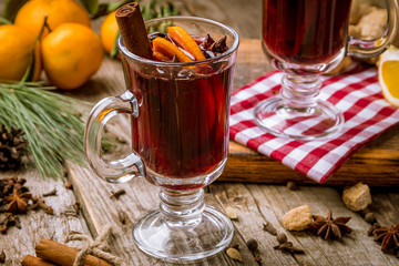 Mulled wine on old wooden background