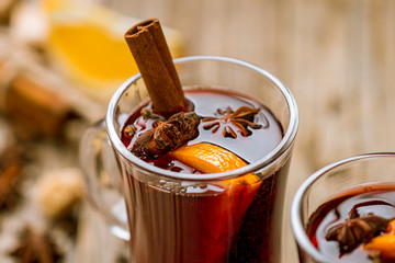 Mulled wine on old wooden background