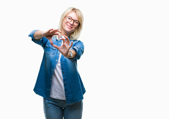 Young beautiful blonde woman wearing glasses over isolated background smiling in love showing heart symbol and shape with hands. Romantic concept.