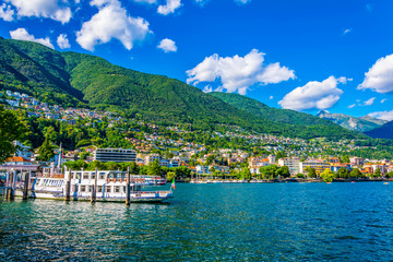 Passenger ferry is arriving to the pier at port at Locarno, Switzerland