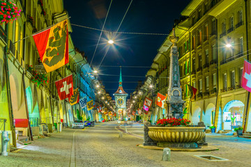 Night view of Kreuzgassbrunnen fountain on Kramgasse - the main street in Bern , Switzerland