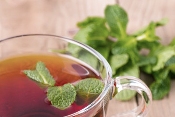 The  tea cup on old wooden background.