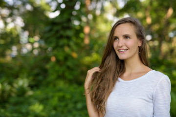 Naklejka premium Close up of happy beautiful woman smiling and thinking while tou