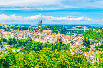 Tower of the cathedral of Saint Nicholas standing over skyline of Fribourg, Switzerland