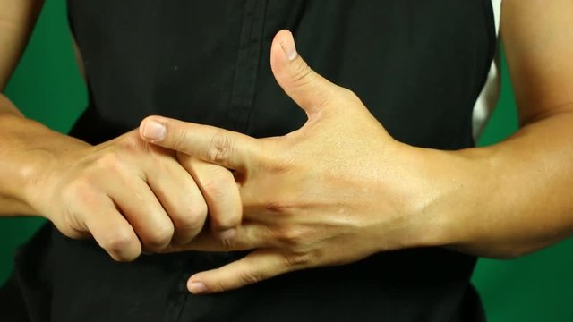 Man massaging  his hand , in studio
