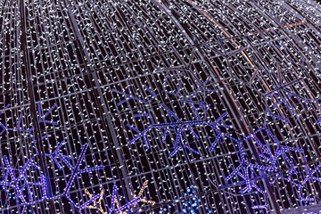 winter holidays decorative lights. glowing blue led garlands. night city decoration