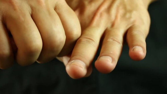 Man massaging  his hand , in studio
