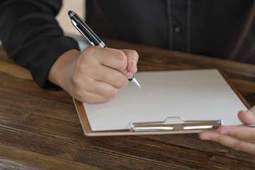 Close up of Hand holding pen, it's like a letter writer. Creative idea of work 2019 goals, writing, drawing,making notes in document.Business,investment,concept,Vintage ,Retro natural mood style.