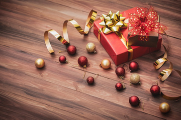 Luxury classic gift boxes with golden ribbon arrange on wood board background decorate with glitter balls, copy space at bottom left