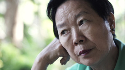 Asian senior elderly woman worry expression thinking about life