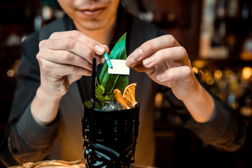 Ready alcoholic cocktail on the background of spice bars in a luxury bar, club, night club, restaurant, pub, evening, weekend