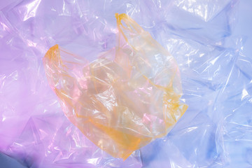 Colorful plastic bag on cement floor background.
