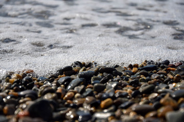 pebble beach on the black sea. the wave in the background.