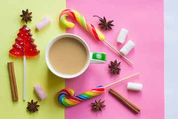 Coffee with milk and lollipop. New Year's coffee. Sweet and drink. Festive mood.