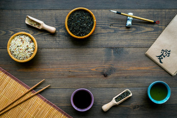 Chinese traditional symbols concept. Tea, rice, hieroglyph symbol, bambootabe mat, chopsticks, soy...