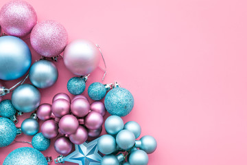 Christmas and New Year symbols. Toys for festive tree. Blue and pink balls and stars on pink background top view space for text border