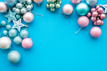 Toys for New Year tree 2019 background. Blue and pink balls and stars on blue background top view space for text border