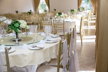 table sets in wedding hall. wedding decorate preparation. table set and another catered event dinner, luxury wedding table setting for fine dining at outdoors.