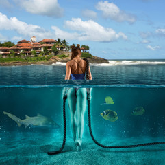 Bikini woman walks on the bottom of the ocean