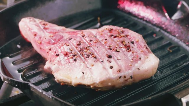 Pork T-Bone steak turned over on pan