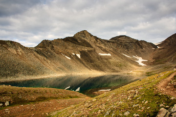 Fototapeta premium Small mountain lake at the feet of the pass