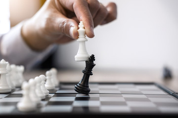 Businessman's hand playing chess game to development analysis new strategy plan, business strategy...
