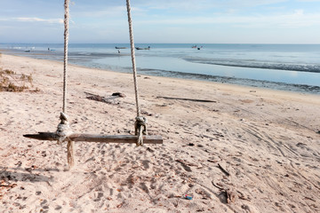 Fototapeta premium Wooden swing hanging on the beach.