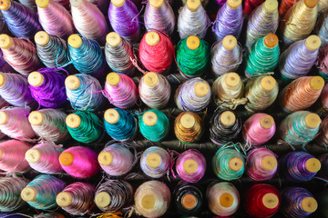 Stack of colorful silk rolls.